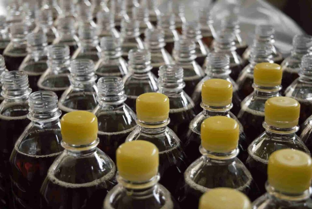many glass bottles with yellow plastic cap