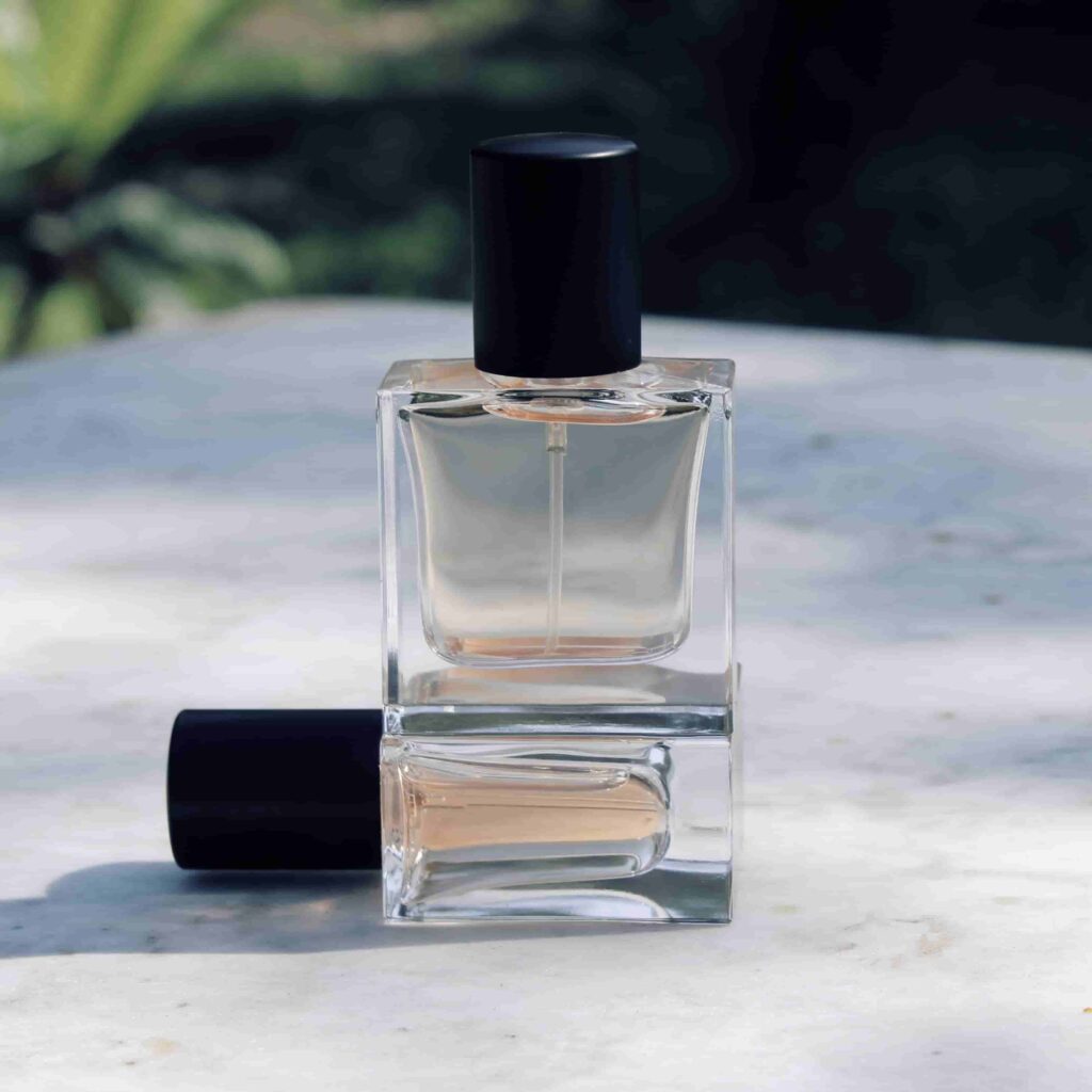 clear glass perfume bottles with black lids