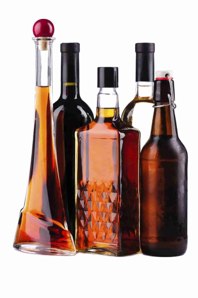 Different bottles of alcohol isolated on a white background