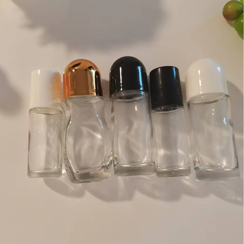 different styles of empty and clear glass roll-on bottles