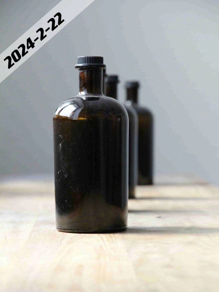 amber glass bottle with black screw lid