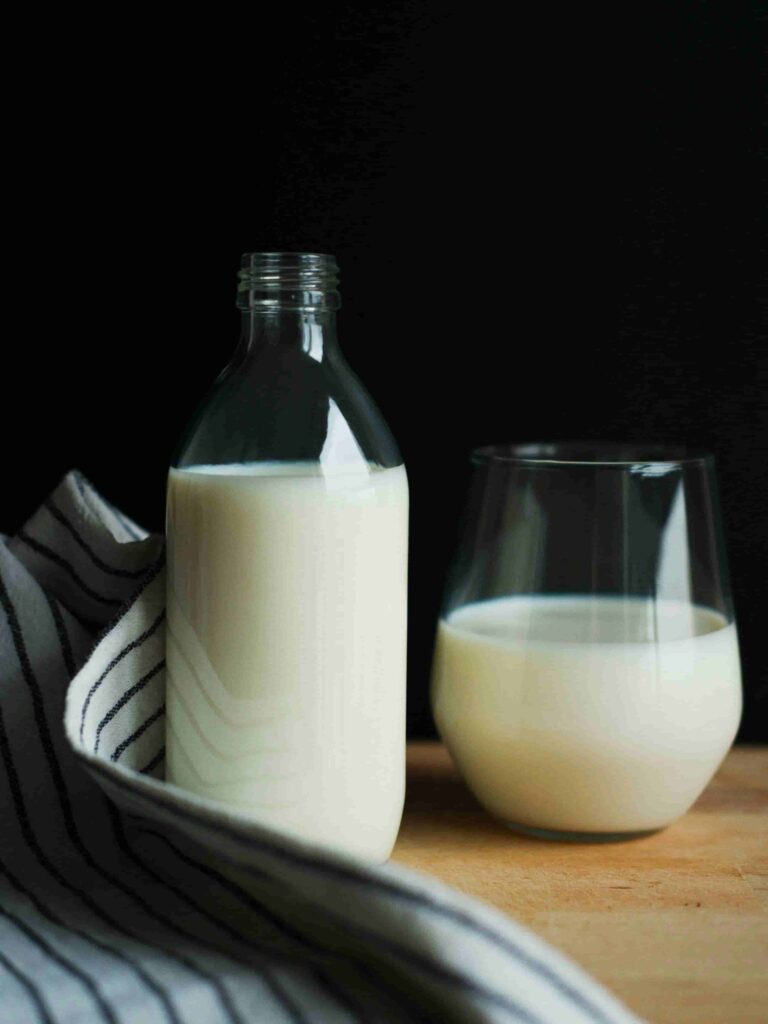 milk in glass bottle and cup