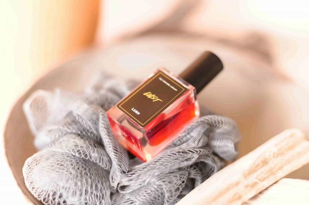 small square perfume bottle with perfume in red
