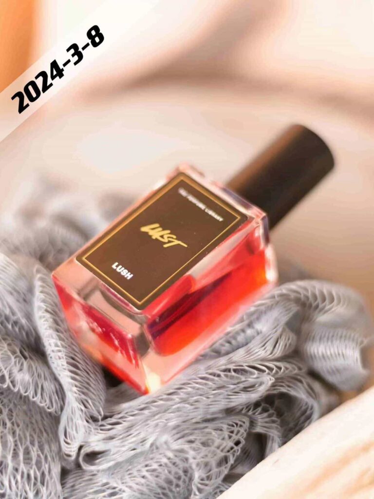 small square perfume bottle with perfume in red