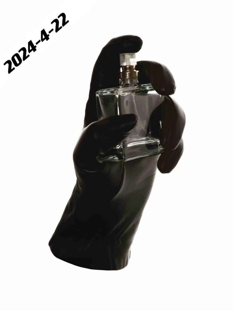 Black glove in hand shape holding a perfume bottle