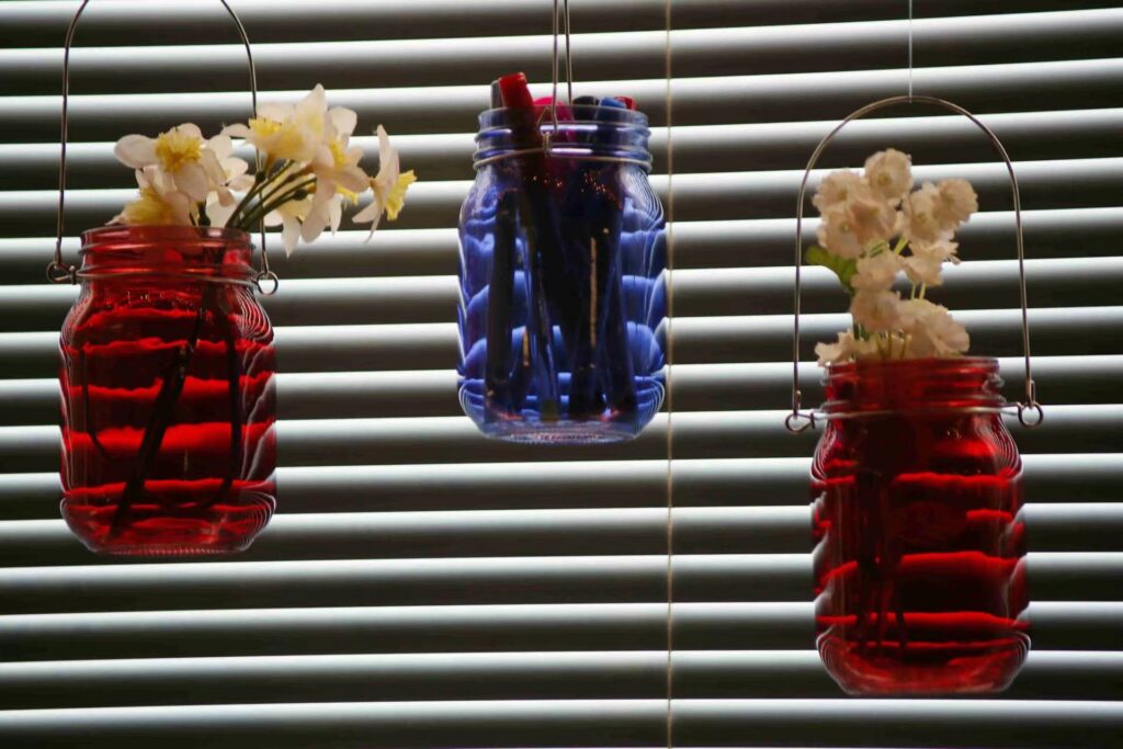 hanging red and blue glass bottle with flowers