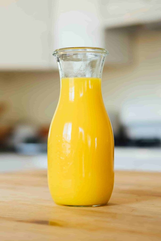 orange juice in glass bottle