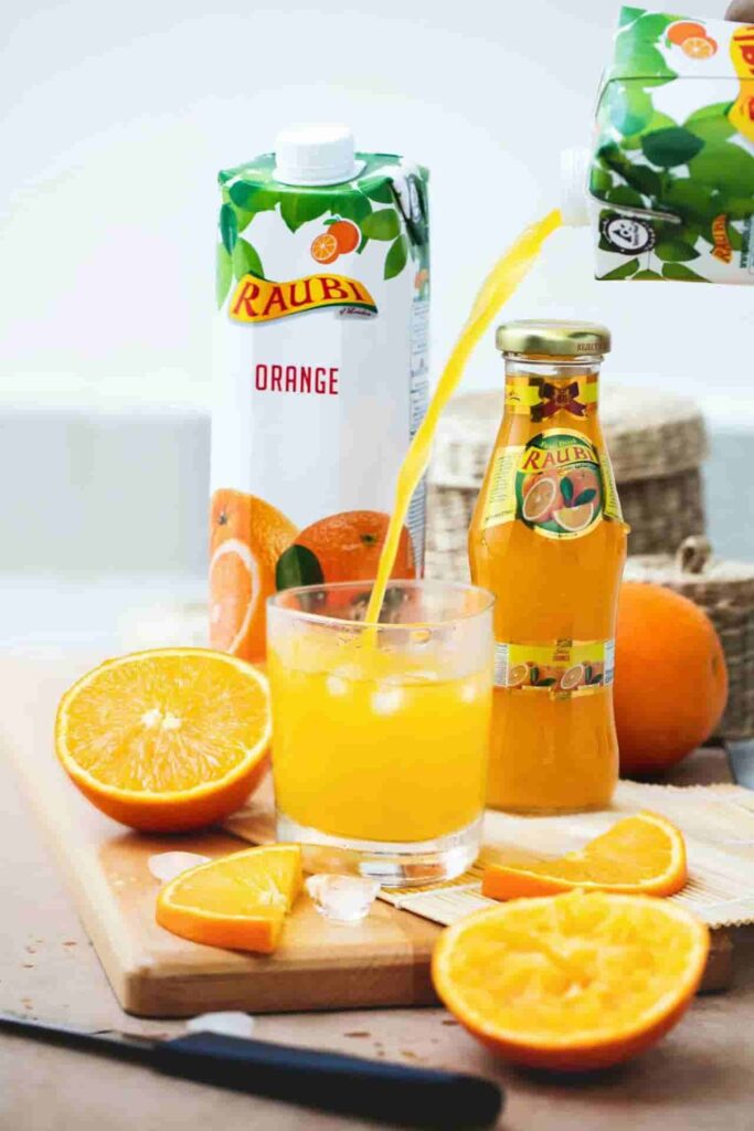 orange juice in glass bottle