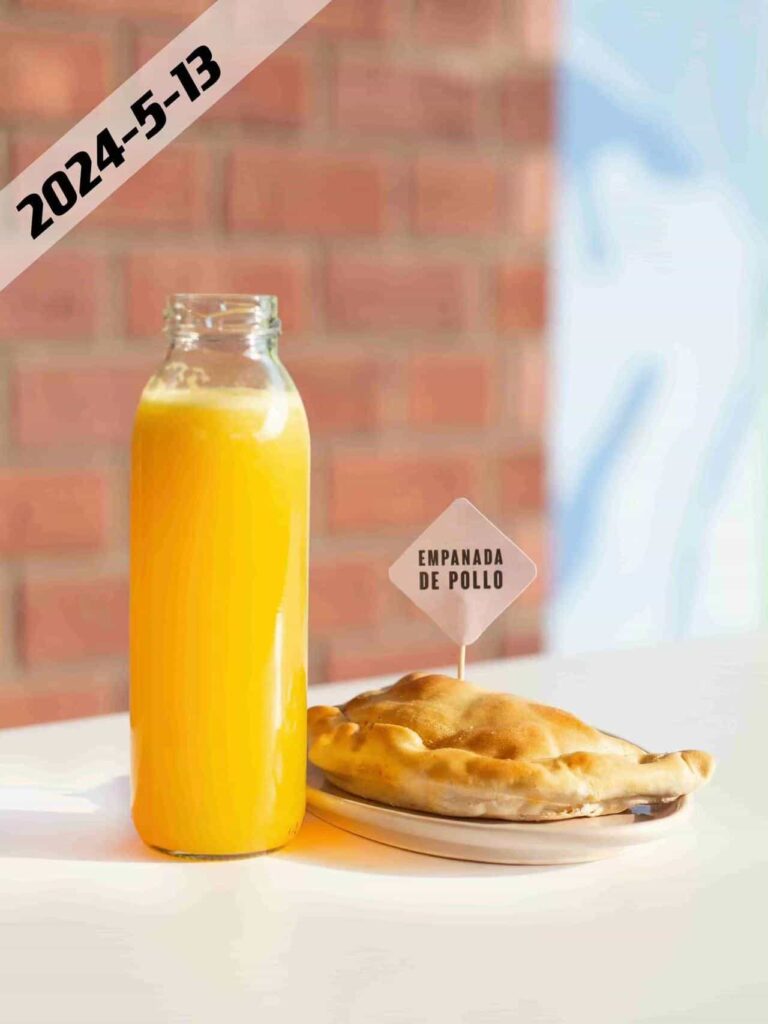 orange juice in glass bottle