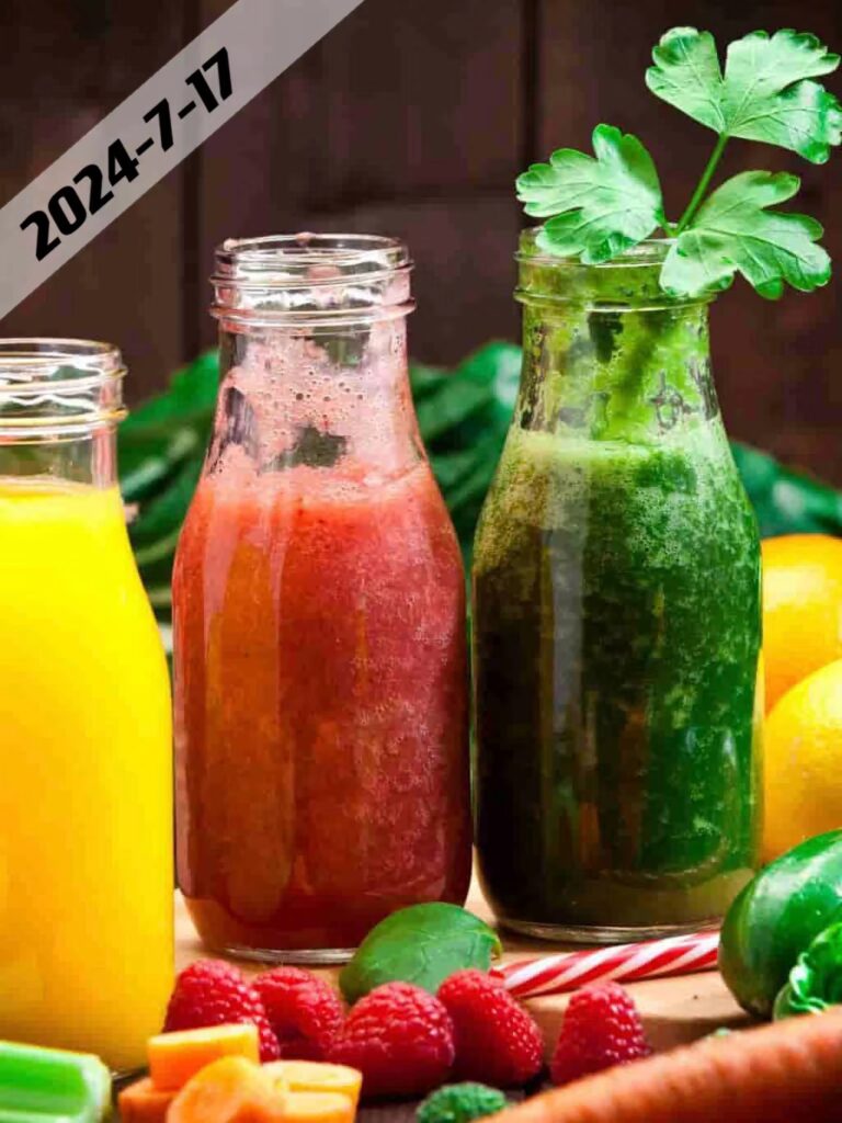 Healthy eating concept: Horizontal shot of three detox drinks in glass bottles with fruits and vegetables all around them on rustic wood table. DSRL studio photo taken with Canon EOS 5D Mk II and Canon EF 70-200mm f/2.8L IS II USM Telephoto Zoom Lens